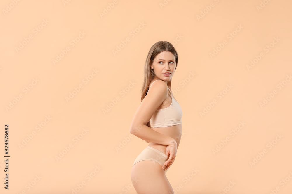 Beautiful young woman in underwear on color background - obrazy, fototapety, plakaty 
