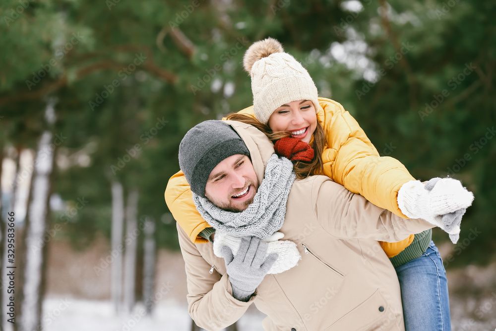 Happy young couple in park on winter day
