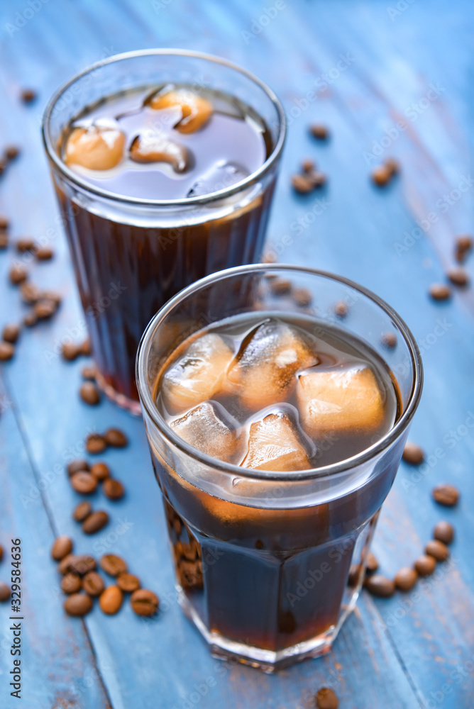 Glasses of tasty iced coffee on table