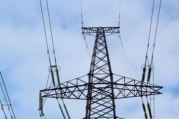 high voltage power lines on background of blue sky