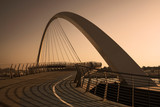 Fototapeta Na drzwi - Futuristic Pedestrian Bridge over the Dubai Water Canal at sunset 