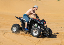 Muscular Man Topless Riding Atv In The Desert