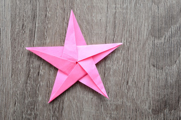 A folded pink paper star