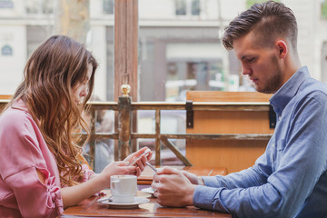 internet addiction, young couple reading social media on their smart phones, phubbing