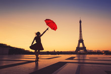 Tourist Travel To Paris, Silhouette Of Happy Woman With Red Umbrella Near Eiffel Tower