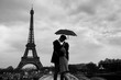 © Song_about_summer - retro view of Paris, couple under umbrella near Eiffel tower, vintage black and white monochrome