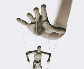 Wall Mural - Concept of control. Marionette in human hand. Black and white image.