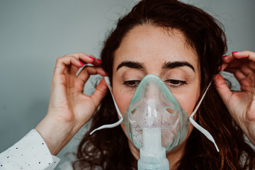 young woman with weak health using assisted breathing at home. treatment of a respiratory disease su