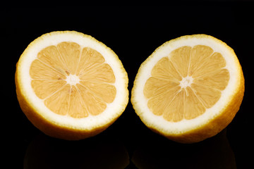 Wall Mural - Yellow lemon closeup cut black background