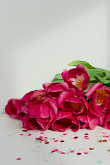 Wall Mural - Vivid bouquet of purple tulips in Still Life on white background. White interior.