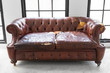 © kasarp - vintage style . Defective old leather sofa on white room