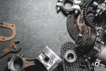 Old car spare parts on dark flat lay background with copy space.