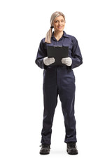 Canvas Print - Female worker in an overall uniform holding a clipboard