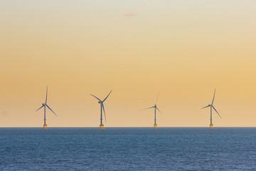 Offshore wind turbines at sunset