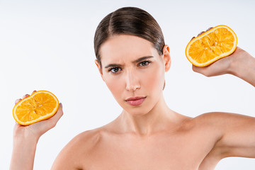 Sticker - Serious woman with orange in hands isolate over white background. Beauty concept