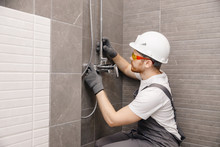 Plumber Installing Water Taps Shower Stall, Work In Bathroom