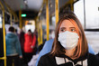 © Photoboyko - Young female adult commutes in a protective face mask. Coronavirus, COVID-19 spread prevention concept, responsible social behaviour of a citizen