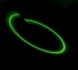 Glowing neon green oblong shape on black background