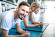 © themorningglory - Sport men and women exercise planking on yoga mat in sport gym together