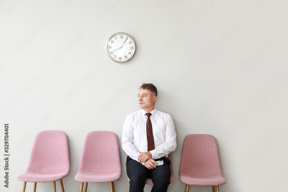 Mature man waiting for job interview indoors