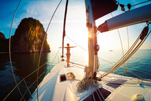 Young Woman Enjoys Sunrise On The Yacht Anchored In The Tropical Sea
