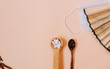 © Aleksandra - comparison of traditional and non-traditional Eastern Chinese medicine. Two wooden spoons, white tablets in one spoon, dry Medecin leaves in the other. A Chinese fan against medical protective masks.