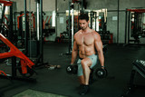 Handsome Man exercise in gym body-building with muscular strong body