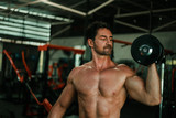 Handsome Man exercise in gym body-building with muscular strong body