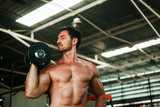 Handsome Man exercise in gym body-building with muscular strong body
