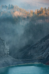 Beautiful view of the light drop on  the trees over the acid lake at Kawah Ijen in Java, Indonesia.