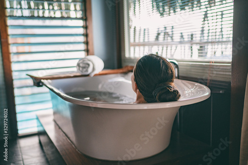Fotomural Bath taking woman relaxing in bathtub of hotel room at luxury overwater bungalow resort in Bora Bora, Tahiti