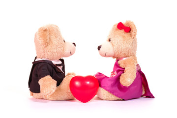 Lovely teddy bear in wedding dress groom bride and red heart sit on white background. Concept wedding of love and valentines.