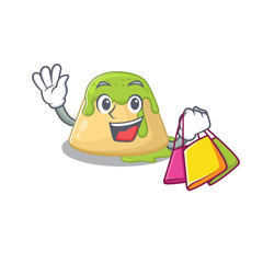 Sticker - Happy rich pudding green tea mascot design waving and holding Shopping bag