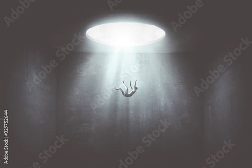 Fotomural man falling down from a hole of light, surreal concept
