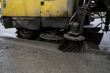 Brushes for cleaning the streets are fixed on the car. Special machinery. Machine with tassels. Car for cleaning in the city. Automatic road cleaning brushes. Washing sidewalks.