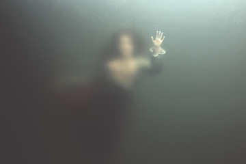 siren woman swimming underwater behind glass surface, surreal concept 