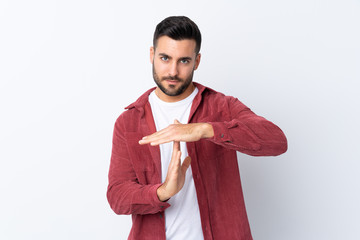 Poster - Young handsome man with beard wearing a corduroy jacket over isolated white background making time out gesture