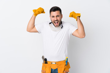 Wall Mural - Craftsmen or electrician man over isolated white background celebrating a victory