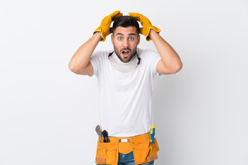 Poster - Craftsmen or electrician man over isolated white background with surprise facial expression