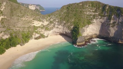 Wall Mural - Beautiful aerial drone shot flying above amazing sea cliff at Kelingking beach of Nusa Penida in exotic holidays travel in Asia and tropical destination concept