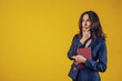 © Kantemir Production - The American woman dressed elegantly as a teacher or business lady, looks in the direction of a free area for text placement, feels knotted with her hand under the beard and with a caranet