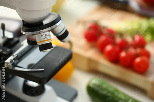 Cuadros en Lienzo Microscope head on kitchen background vegetables concept nitrates