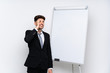 © luismolinero - Young businessman giving a presentation on white board has realized something and intending the solution