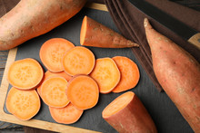 Sweet Potato, Board And Towel On Wooden Background, Top View