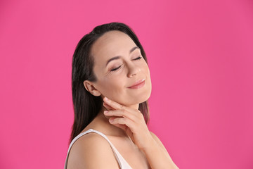 Poster - Portrait of beautiful mature woman on pink background