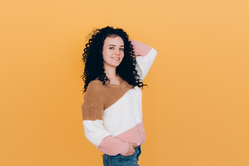 beautiful curly girl posing on camera with black curly hair