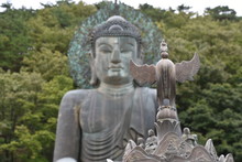 Giant Buddha In Background, Phoenix Incense Urn In Foreground, Seoraksan National Park, South Korea