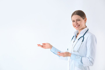 Sticker - Portrait of young doctor against white background