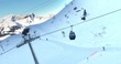 Ski lifts going up and down in the Swiss Alps. People are skiing below. Captured by drone.