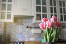 A Bouquet Of Pink Tulips On A Background Of Bright Kitchen. Place For Text.